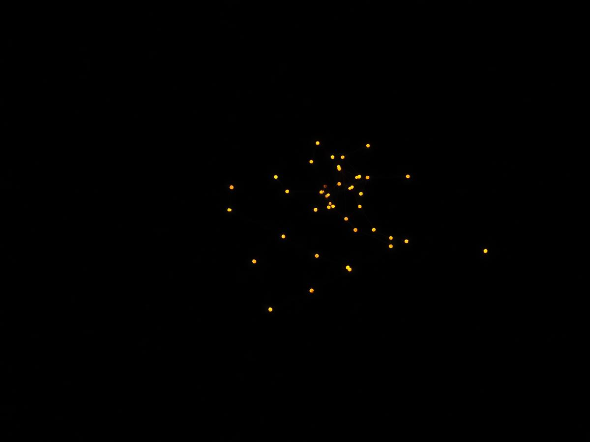 A constellation of small gold nodes connected by thin threads of light